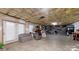 Unfinished basement with storage shelves, seating, and a door to the outside at 101 Saddletree Rd, Lincolnton, NC 28092