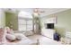 Bedroom with light green walls, plush pink bedding, and neutral carpet at 101 Saddletree Rd, Lincolnton, NC 28092