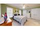 Well-lit bedroom showcasing a neatly made bed, white trim, and ample closet space at 101 Saddletree Rd, Lincolnton, NC 28092