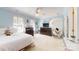 Stylish bedroom with light blue walls, a ceiling fan, and a cozy seating area at 101 Saddletree Rd, Lincolnton, NC 28092