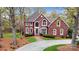 Beautiful brick home with manicured lawn, mature trees, and a winding driveway leading to a stately entrance at 101 Saddletree Rd, Lincolnton, NC 28092