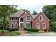 Charming red brick home with manicured lawn and mature landscaping on a sunny day at 101 Saddletree Rd, Lincolnton, NC 28092
