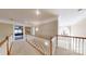Spacious hallway with carpeted floors, white railings, and a view of the downstairs chandelier at 101 Saddletree Rd, Lincolnton, NC 28092