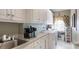 Laundry room with white cabinetry, utility sink, washer, and dryer at 101 Saddletree Rd, Lincolnton, NC 28092
