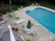 Aerial view of a sparkling in-ground pool with surrounding patio, lounge chairs and outdoor seating at 101 Saddletree Rd, Lincolnton, NC 28092