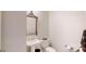 Neutral powder room features a pedestal sink and decorative mirror at 101 Saddletree Rd, Lincolnton, NC 28092