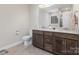 Modern bathroom with double sink vanity, granite countertop, dark cabinets, and tile flooring at 1027 Williamston Dr, Marshville, NC 28103