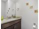 Half bath with granite countertop vanity and decorative mirror and wall art at 1027 Williamston Dr, Marshville, NC 28103