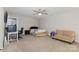 Bedroom with a ceiling fan, desk, couch, and a bed with patterned covers at 1027 Williamston Dr, Marshville, NC 28103