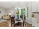 Bright dining area with a chandelier and lots of windows overlooking the backyard at 1027 Williamston Dr, Marshville, NC 28103