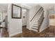 Bright entryway featuring wood floors, staircase, and access to kitchen and front door at 1027 Williamston Dr, Marshville, NC 28103