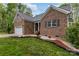 Charming brick home with manicured landscaping including mulch and flowers at 1027 Williamston Dr, Marshville, NC 28103