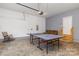 Spacious garage with a ping pong table, stairs to a side exit, and a seating area at 1027 Williamston Dr, Marshville, NC 28103