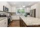 Modern kitchen with white cabinets, stainless steel appliances, and granite countertops at 1027 Williamston Dr, Marshville, NC 28103
