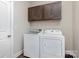 Laundry room with a washer, dryer, and cabinets for storage above with wood-look flooring at 1027 Williamston Dr, Marshville, NC 28103