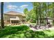 Expansive backyard featuring a stone patio with a pergola, outdoor fireplace, and lush lawn at 1029 Seminole Dr, Waxhaw, NC 28173