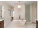 Bright bathroom with a modern tub, glass shower, stylish lighting, and a heated towel rack at 1029 Seminole Dr, Waxhaw, NC 28173