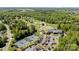 Aerial shot of community with golf course, tennis courts, clubhouse, and lush greenery at 1029 Seminole Dr, Waxhaw, NC 28173