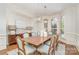Elegant dining room with hardwood floors, bay windows, and modern chandelier at 1029 Seminole Dr, Waxhaw, NC 28173