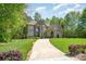 An exterior view of a luxury home with a long driveway and well-maintained landscaping at 1029 Seminole Dr, Waxhaw, NC 28173