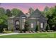 Stunning two-story home with stone accents, arched entryway and lush landscaping at 1029 Seminole Dr, Waxhaw, NC 28173