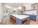 Bright, modern kitchen with a large island, stainless steel appliances, and hardwood floors at 1029 Seminole Dr, Waxhaw, NC 28173