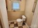 Bathroom with a toilet, tile flooring, and a small window at 109 Starnes St, Chester, SC 29706