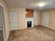 Living room with non-working fireplace, wood panels, carpet and multiple doorways at 109 Starnes St, Chester, SC 29706