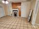 Living room view showcasing fireplace, tile flooring and access to additional rooms at 109 Starnes St, Chester, SC 29706