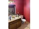 Bathroom with a mirror, toilet, and sink set in a wooden vanity with storage at 1336 Mt Sinai Church Rd, Shelby, NC 28152