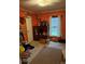 Bedroom featuring orange walls, one window with curtains, and a ceiling fan fixture at 1336 Mt Sinai Church Rd, Shelby, NC 28152