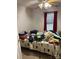 Bedroom showcasing a cluttered bed with red curtains and a ceiling fan at 1336 Mt Sinai Church Rd, Shelby, NC 28152