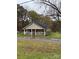 Charming single-story home featuring a welcoming porch, neutral siding, and a contrasting black roof at 1336 Mt Sinai Church Rd, Shelby, NC 28152