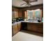 Traditional kitchen with wood cabinets, double bowl sink, black dishwasher, and a breakfast bar at 1336 Mt Sinai Church Rd, Shelby, NC 28152
