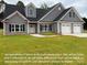 Charming two-story home with gray siding, black shutters, white trim, and an attached two-car garage at 135 Falls Leaf Dr # 14, Troutman, NC 28166