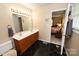 Bathroom with a double sink vanity, black tile floors and a large mirror at 1353 33Rd Avenue Ne Dr, Hickory, NC 28601