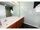 Bathroom featuring a double sink vanity with a large mirror and dark tiled flooring at 1353 33Rd Avenue Ne Dr, Hickory, NC 28601