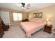 Comfortable bedroom with carpet and ceiling fan, complemented by a window and decor at 1353 33Rd Avenue Ne Dr, Hickory, NC 28601