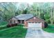 Charming brick home features a two-car garage, manicured lawn, and mature trees at 1353 33Rd Avenue Ne Dr, Hickory, NC 28601