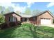 Charming brick home with a well-maintained lawn, featuring a two-car garage and cozy porch at 1353 33Rd Avenue Ne Dr, Hickory, NC 28601