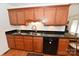 Spacious kitchen features stainless steel sink, black appliances, wood cabinetry, and granite countertops at 1353 33Rd Avenue Ne Dr, Hickory, NC 28601