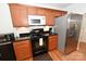 Efficient kitchen includes microwave, stove, and refrigerator with lovely wood cabinets and granite countertops at 1353 33Rd Avenue Ne Dr, Hickory, NC 28601
