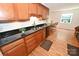 Traditional kitchen featuring granite countertops, wood cabinets and flooring and stainless steel sink at 1353 33Rd Avenue Ne Dr, Hickory, NC 28601