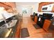 Bright kitchen showcasing sleek black appliances, wood cabinets, granite countertops, and hardwood flooring at 1353 33Rd Avenue Ne Dr, Hickory, NC 28601