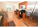 Well-equipped kitchen with stainless steel refrigerator, black appliances, wood cabinets and gleaming granite countertops at 1353 33Rd Avenue Ne Dr, Hickory, NC 28601