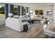 Spacious living room with natural light, a large sofa, stylish decor, and hardwood flooring at 1468 Honey Trl, Monroe, NC 28112