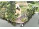Scenic aerial view of waterfront property featuring a modern home, dock, and serene lake setting at 15170 Cove Point Ln, Norwood, NC 28128