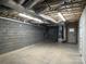 Unfinished basement with block walls and utility hookups offering potential for customization at 15170 Cove Point Ln, Norwood, NC 28128