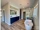 Bright bathroom featuring a double sink vanity, modern lighting, and separate glass shower and tub at 15170 Cove Point Ln, Norwood, NC 28128