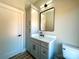 Stylish bathroom featuring a modern vanity, sleek fixtures, and a well-placed mirror, optimizing space at 15170 Cove Point Ln, Norwood, NC 28128